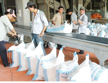 Workers package rice for export at a rice processing factory of the Southern Food Comapny in Ho Chi Minh City.