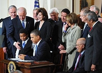 US President Barack Obama signs the health insurance reform bill in the East Room of the White House in Washington. AFP photo