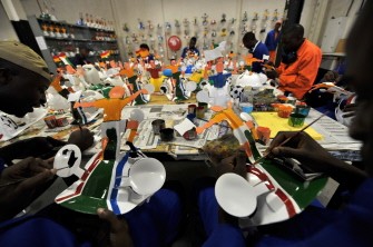 A picture taken on March 4, 2010 shows employees preparing a football player on a hardhat known as Makarapas in Johannesburg. AFP photo