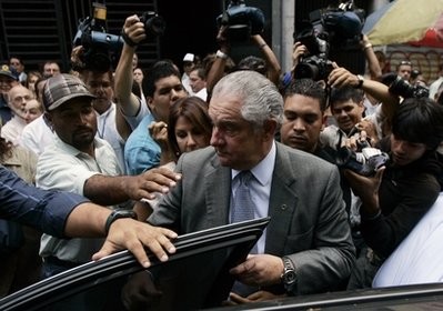 In this photo taken June 4, 2009, the president of Globovision television channel Guillermo Zuloaga, center, surrounded by bodyguards and media, leaves the attorney general's office in Caracas, Venezuela.