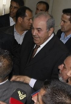 Premier-elect Iyad Allawi is surrounded by security and cameras in Baghdad. Allawi, whose bloc emerged strongest from Iraq's polls, launched talks Saturday with political foes in a bid to form a coalition (AFP photo)
