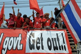 Red Shirt supporters wave flags during an anti-government protest at the 11th Infantry Barracks in Bangkok on March 28, 2010. AFP photo