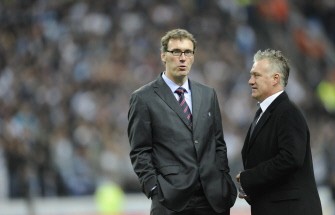 Marseille's coach Didier Deschamps (R) chats with Bordeaux' coach Laurent Blanc at the end of the League Cup final football match Marseille vs. Bordeaux on March 27, 2010 at the Stade-de-France stadium in Saint-Denis, outside Paris. Marseille won 3 to 1. AFP PHOTO