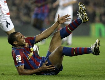 Thiery Henry falls during a Spanish League football match against Osasuna at the Camp Nou Stadium in Barcelona, on March 24, 2010. AFP PHOTO