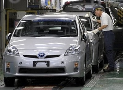 File photo shows a factory worker checking an assembled Prius hybrid vehicle in its final stage of the assembly line at Toyota Motors' Tsutsumi factory in Toyota.