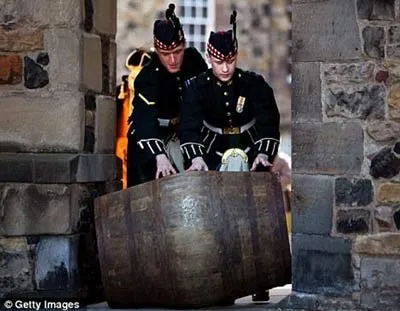 Kris Green và Alan Leiper thuộc trung đoàn Hoàng gia Scotland đẩy thùng rượu scotch whisky Mortlach duy nhất ra khỏi hầm.