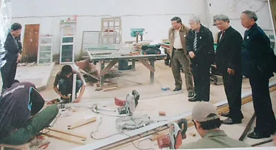 Cựu chiến binh Nguyễn Lương Cảnh (đứng thứ 2 từ phải qua) hướng dẫn các cựu chiến binh xem các học viên Lào học nghề tại cơ sở của gia đình.