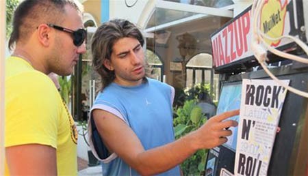 Dima, a Russian, introduces that night’s music performance at Déjà vu restaurant in Mui Ne to a countryman.