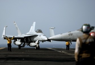 US crewmen guide an F-18 jet fighter before take off on the deck of the USS Eisenhower aircraft carrier in the Arabian sea on May 24, 2010. The USS Eisenhower is on a mission to support US-led coalition forces in Afghanistan. AFP PHOTO