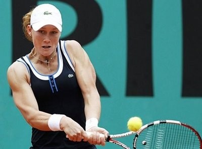 Stosur returns the ball to Justine Henin during their women's fourth round match. AFP photo