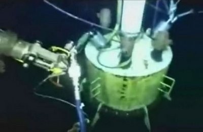 This still image from a live BP video shows a cap being lowered in the hopes of sealing the fractured oil pipe spill in the Gulf of Mexico. AFP