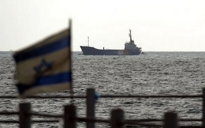 An Israeli flag flutters in the foreground as the Rachel Corrie aid ship enters the military port of Ashdod in southern Israel. AFP photo