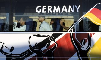 Germany's defender Philipp Lahm (L) and Germany's goalkeeper Manuel Neuer arrive in the team bus for a training session of the German team in Atteridgeville, near Pretoria on June 9, 2010. AFP photo