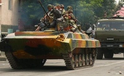 Kyrgyz soldiers drive an armoured vehicle through the streets in Osh. AFP photo