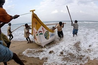 File photo shows Indian fishermen bringing their boat to shore following a tsunami warning in Chennai