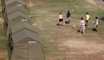 Australian supporters play a makshift game of football next to an array of tents on the grounds of the Kingsmead Sahara Cricket Grounds in Durban on June 12, 2010. AFP photo