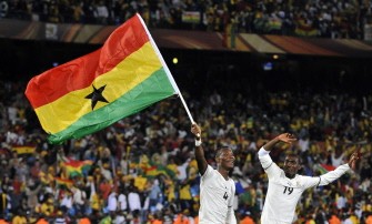 Ghana's defender John Paintsil (L) waves his national flag as he celebrates with Ghana's defender Lee Addy winning 1-0 over Serbia on June 13, 2010.