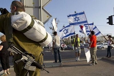 Israelis wave their national flag as they demonstrate in the coastal city of Netanya in support of their army and against Turkey, following a raid by Israeli forces on a Gaza-bound aid flotilla. AFP photo