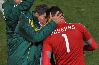 Parreira (L) talks to South Africa's goalkeeper Moeneeb Josephs before Josephs enters the game to defend the goal in a penalty kick, after keeper Khune (unseen) was given a red card. AFP