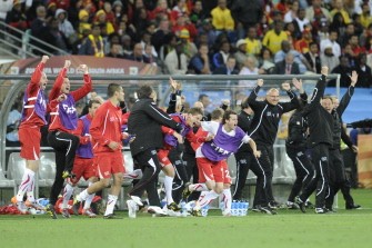 Swiss players and coaches celebrate after the match Spain versus Switzerland on June 16, 2010. AFP PHOTO
