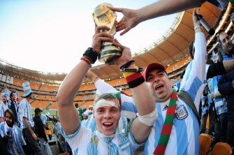 Argentina supporters celebrate their team's victory with a replica of the World Cup trophy after the football match between Argentina and South Korea on June 17, 2010. AFP