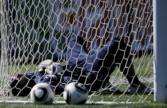 Italy's goalkeeper Federico Marchetti lies inside the goal during training session at Irene's Southdown College, south of Pretoria on June 17, 2010. AFP