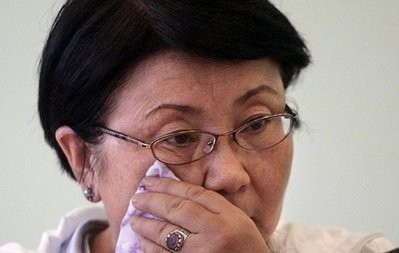 Kyrgyzstan's interim leader Roza Otunbayeva wipes her face during a meeting with people in Osh.