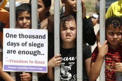 Palestinian children demonstrate to demand the opening of the crossings and the ending of the siege on the Gaza Strip in Gaza City on June 20, 2010.