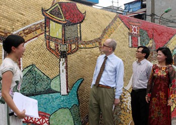 Italian artist Giuseooe Mastropierro's ceramic mosac, part of a giant mural along the Red River in Hanoi, is presented to viewers on June 22.