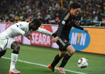 Mesut Ozil (R) fights for the ball with Ghana's defender Jonathan Mensah during match Germany versus Ghana on June 23. AFP