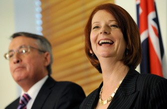 Australia's new prime minister Julia Gillard (R) smiles with new deputy prime minister Wayne Swann (L), in Canberra on June 24, 2010. AFP