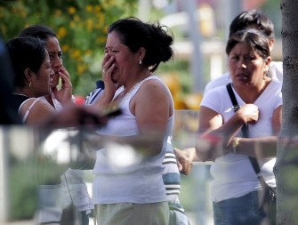 Women cry outside the Legal Medicine Institute of Barcelona where the bodies of the victims of a train crash were sent for identification on June 24, 2010. AFP