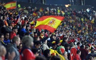 Supporters of Spain wave the national flag during the match between Chile and Spain on June 25, 2010. AFP