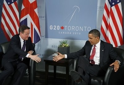 Britain's Prime Minister David Cameron, left, and U.S. President Barack Obama, right, reach out to shake hands during their bilateral meeting on the sidelines of the G20 summit in Toronto, Saturday, June 26, 2010