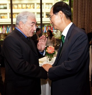 Dominique Strauss-Kahn (L) shakes hands with the Ambassador from South Korea Han Duk-soo (R) during a reception for Asian Ambassadors at the IMF Headquarters June 30, 2010 in Washington, DC. AFP PHOTO