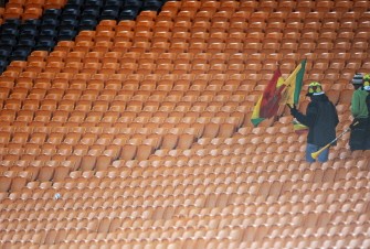 Two supporters of Ghana leave the stands of Soccer City stadium at the end of the match between Uruguay and Ghana on July 2, 2010. AFP