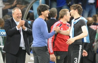 Joachim Loew (C, L) shakes hands with Germany's defender Arne Friedrich after they won the quarter-final match Argentina vs. Germany on July 3, 2010. AFP