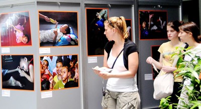 Visitors contemplate pictures exhibited at the War Remnants Museum. (Photo: SGGP)