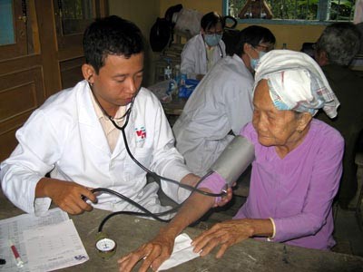 A doctor examines an old woman at a clinic in the Mekong Delta province of Hau Giang