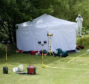 Forensics officers at the scene of an armed stand-off in Rothbury, northeast England. AFP