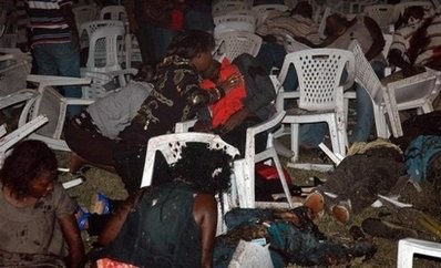 People look for survivors at an Ethiopian-owned restaurant in the Kabalagala area of Kampala. AFP