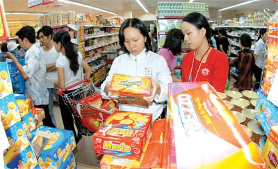 Shoppers check out locally made foods at a supermarket in Ho Chi Minh City