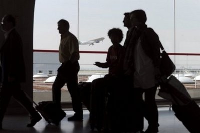File photo shows passengers walking through Roissy-Charles-de-Gaulle airport as a plane takes off