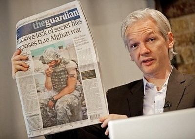 Australian founder of whistleblowing website, 'WikiLeaks', Julian Assange, holds up a copy of today's Guardian newspaper during a press conference in London.