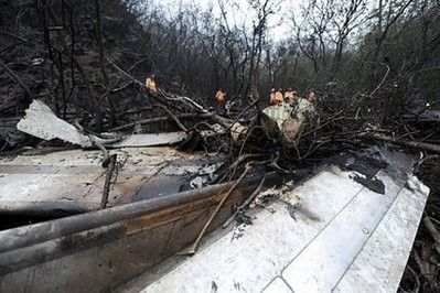 Pakistani rescue workers search at the site of the wreckage of a crashed passenger plane on the day after the accident in The Margalla Hills on the outskirts of Islamabad.