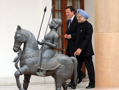 British Prime Minister David Cameron (L) and Indian Prime Minister Manmohan Singh arrive for a meeting prior to delegation level talks and agreement signing in New Delhi.