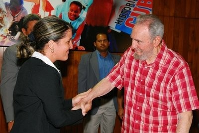 In this photo released by the state media Cubadebate web site, Cuba's former leader Fidel Castro, right, shakes hands with Yailin Orta Rivera, Juventud Rebelde journalist and professor at the Communications College at the University of Havana, during a meeting with youth at the Havana Convention Center in Havana, Cuba, Friday July 30, 2010.