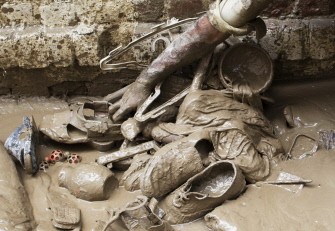 Pakistani man gathers up some of his belongings outside his flooded house in Nowshera on August 2, 2010. AFP