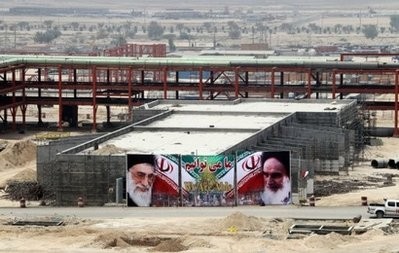 Banner bearing portraits of Iran's supreme leader Ayatollah Ali Khamenei (L) and his predecessor, the founder of the Islamic republic, Ayatollah Ruhollah Khomeini (R), are seen on a construction site for the South Pars gas field development in the Iranian port town of Asaluyeh on July 19, 2010.