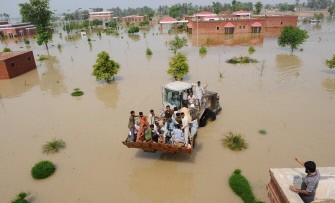 Pakistani soldiers use a loader to rescue Lal Pir Thermal Power employees during flooding in Lal Pir on August 7, 2010. AFP